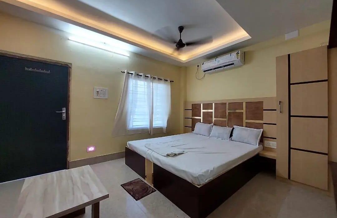 Clean air-conditioned room interior with bed and wardrobe, Dakshina Hawa Resort