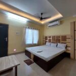 Clean air-conditioned room interior with bed and wardrobe, Dakshina Hawa Resort
